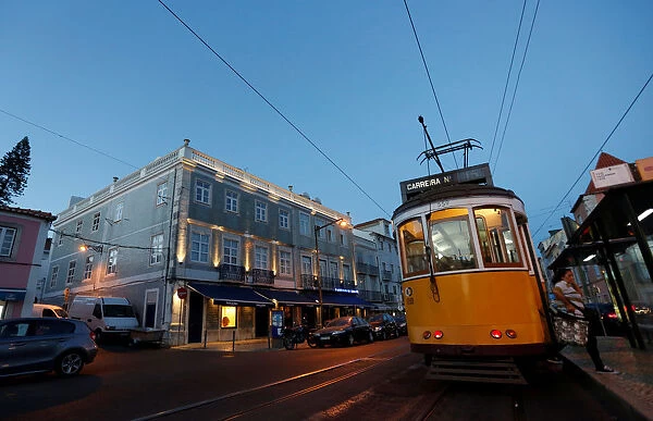 A tram passes by the Pasteis de Belem cafe in Lisbon