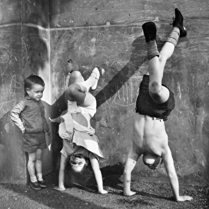 Children doing handstands on a Balham street, SW London