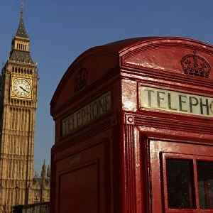 Big Ben is seen behind a red telephone box, in central London