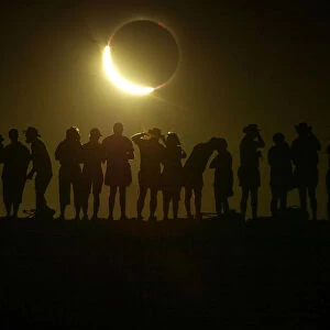 A SOLAR ECLIPSE OCCURS ABOVE THE AUSTRALIAN OUTBACK TOWN OF LYNDHURST