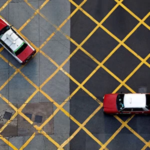 Taxis cross a street near Wan Chai station in Hong Kong