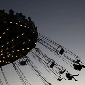 Visitors enjoy a ride in an amusement park in Nicosia