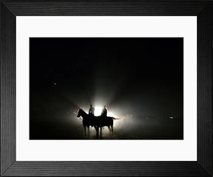 Framed Print : Israeli policemen sit on their horses in a standby position on the field outside