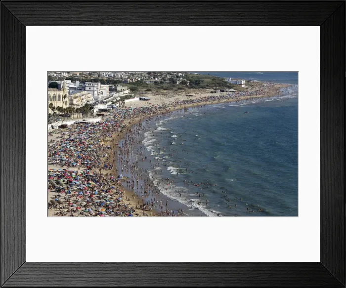 Framed Print : People gather in the Virgen de Regla beach in Chipiona, southern Spain Framed Print : People gather in the Virgen de Regla beach in Chipiona, southern Spain