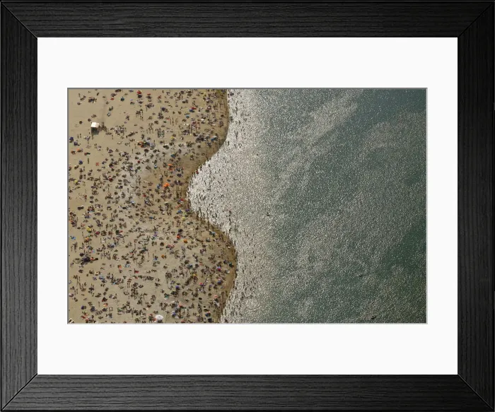 Framed Print : An aerial view shows people at a beach on the shores of the Silbersee lake on a hot Framed Print : An aerial view shows people at a beach on the shores of the Silbersee lake on a hot