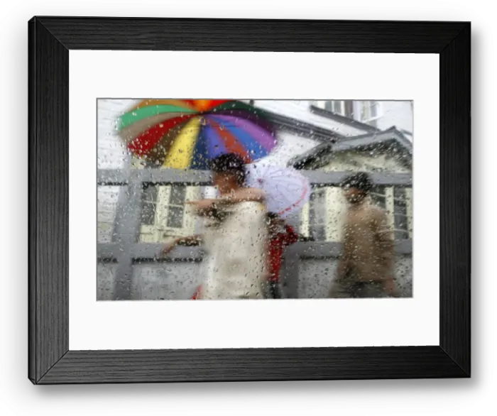 Framed Print : Pedestrians are seen through a car window during rainfall in Darjeeling Framed Print : Pedestrians are seen through a car window during rainfall in Darjeeling