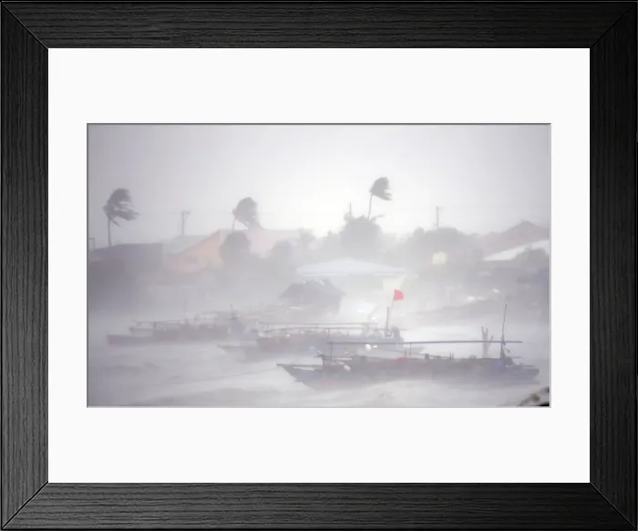 Framed Print : Fishing boats are pictured amid heavy winds and rain brought by Typhoon Rammasun as