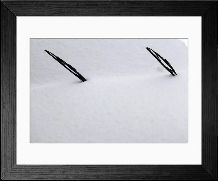 Framed Print : Windscreen wipers of a snow-covered car are seen in Bucharest Framed Print : Windscreen wipers of a snow-covered car are seen in Bucharest