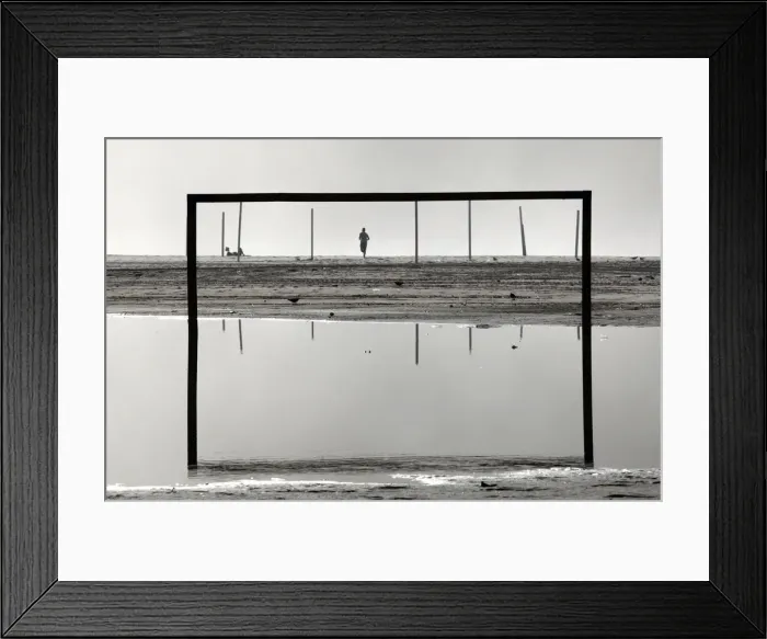 Framed Print : A man runs on Copacabana beach after heavy rains in Rio de Janeiro