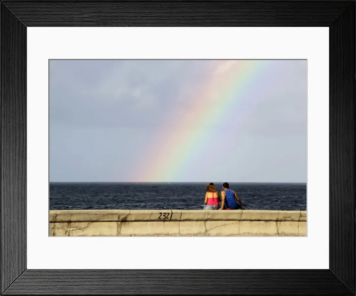 Framed Print : A couple watches a rainbow from Havanas seafront boulevard El Malecon Framed Print : A couple watches a rainbow from Havanas seafront boulevard El Malecon