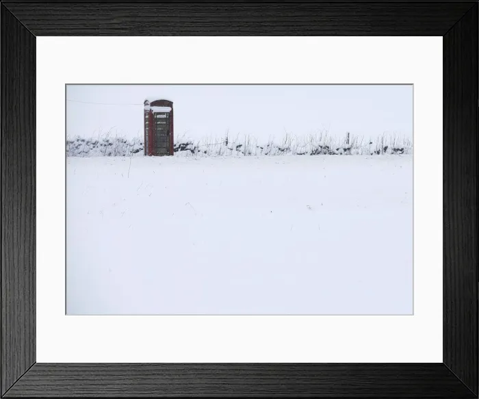 Framed Print : A phone box stands in snow in Newhaven