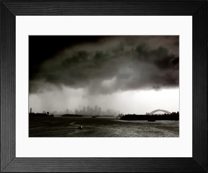 Framed Print : Boats sail on Sydney harbour as a severe storm hits the city