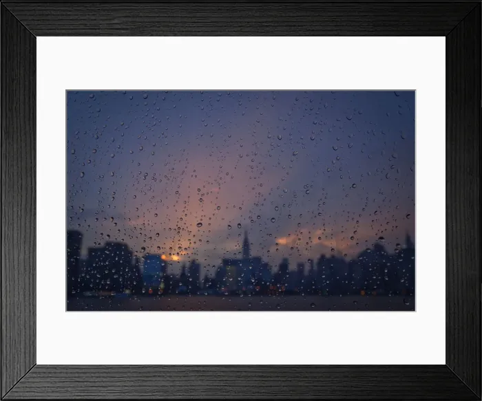 Framed Print : Rain is seen on a window of a ferry boat as it passes midtown Manhattan and the Empire Framed Print : Rain is seen on a window of a ferry boat as it passes midtown Manhattan and the Empire