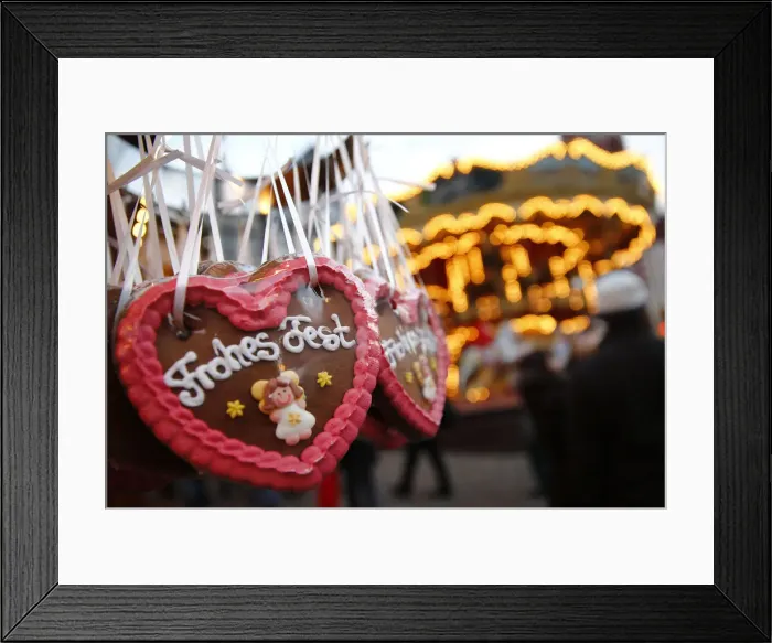 Framed Print : Gingerbread hearts reading Merry Christmas are on display at a booth at the opening Framed Print : Gingerbread hearts reading Merry Christmas are on display at a booth at the opening