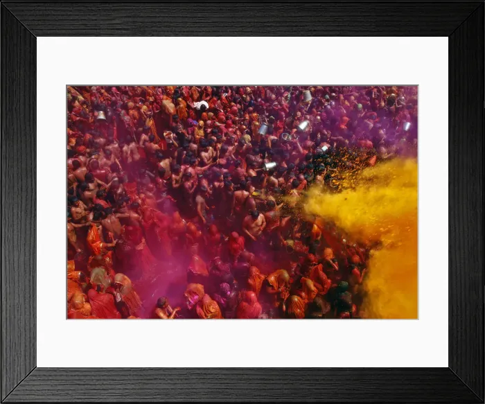 Framed Print : Women cover themselves as men pour coloured water on them during Huranga at Dauji