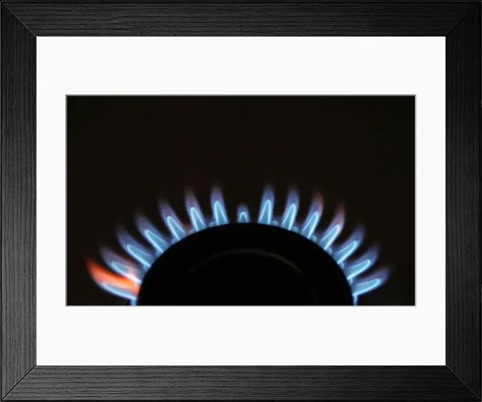 Framed Print : Gas flames are seen burning on a cooker in London Framed Print : Gas flames are seen burning on a cooker in London