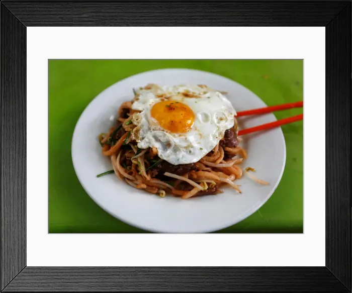 Framed Print : Noodle with egg is seen on a table along a street during breakfast in Phnom Penh