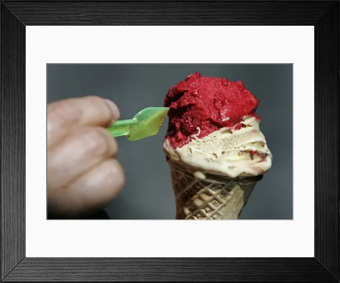 Framed Print : A woman enjoys an ice cream outside Giolitti ice-cream shop in downtown Rome Framed Print : A woman enjoys an ice cream outside Giolitti ice-cream shop in downtown Rome