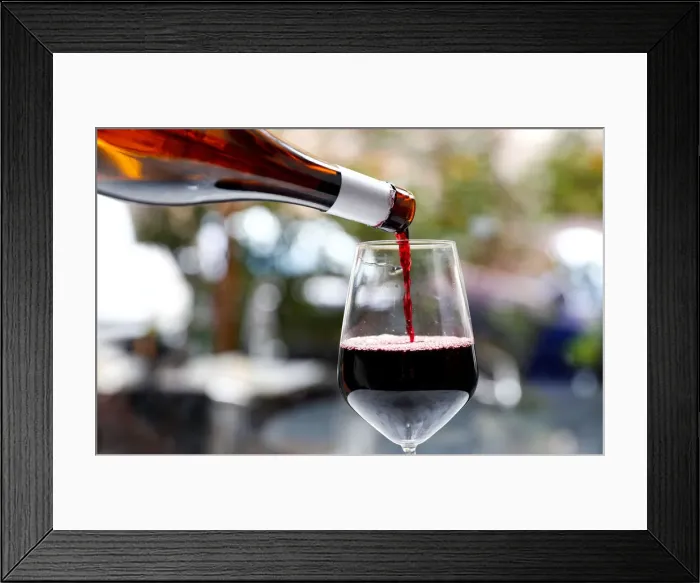 Framed Print : Red wine is poured in a glass in a wine shop in Rome Framed Print : Red wine is poured in a glass in a wine shop in Rome