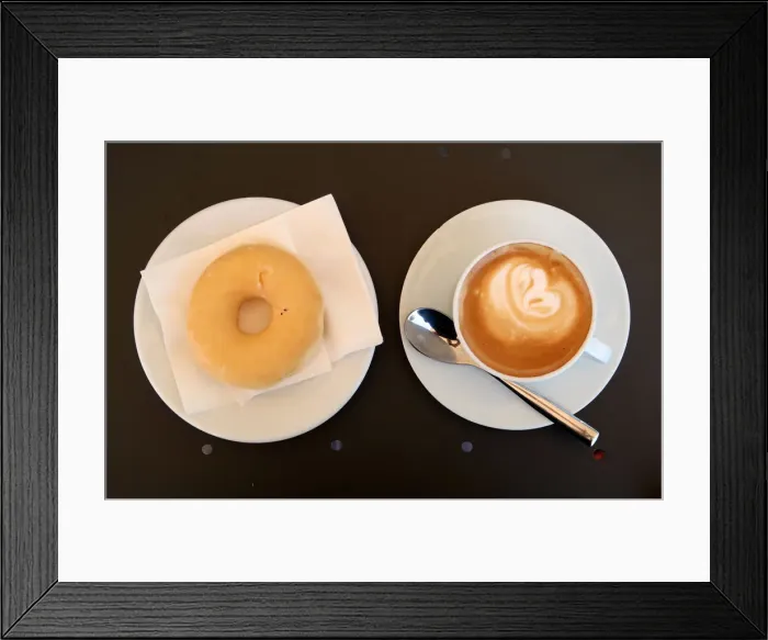 Framed Print : A coffee with milk and a donut are served in bakery in Vilassar de Dalt town Framed Print : A coffee with milk and a donut are served in bakery in Vilassar de Dalt town