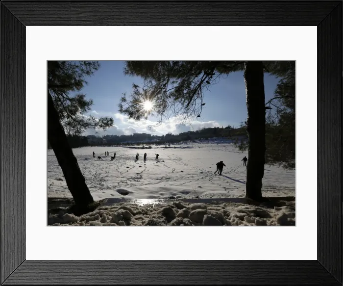 Framed Print : People play with snow after a heavy snowstorm in Amman Framed Print : People play with snow after a heavy snowstorm in Amman