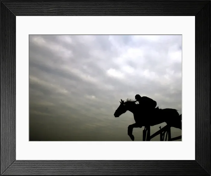 Framed Print : An Indian horse rider jumps an obstacle during a horse show in Kolkata