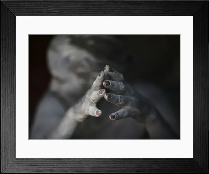 Framed Print : Ash-encrusted hands of a sadhu are seen as he sits beside a fire after applying ashes to his face Framed Print : Ash-encrusted hands of a sadhu are seen as he sits beside a fire after applying ashes to his face