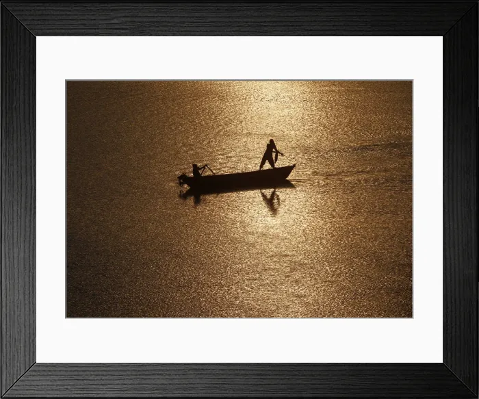Framed Print : Girls are silhouetted against the rising sun as they fish in the waters of the Ganges Framed Print : Girls are silhouetted against the rising sun as they fish in the waters of the Ganges
