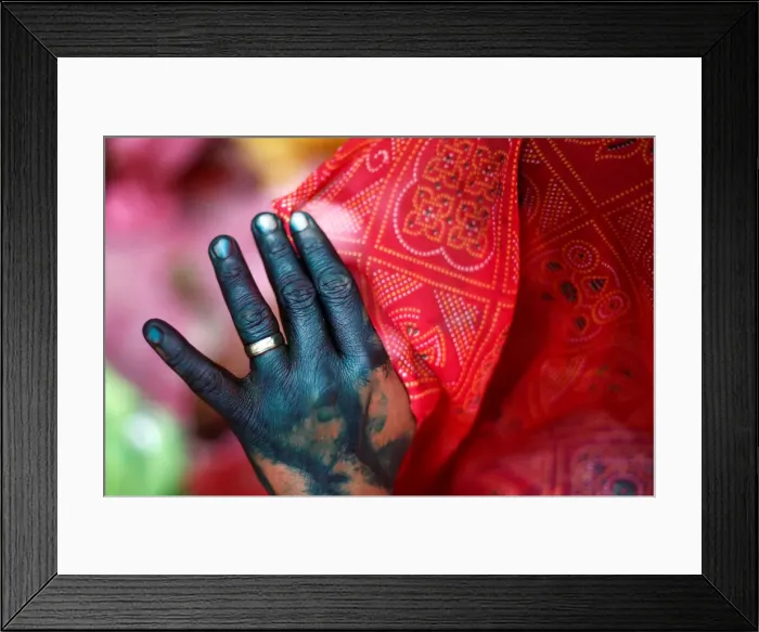 Framed Print : A woman holds her veil as she takes part in Huranga, a game played between men Framed Print : A woman holds her veil as she takes part in Huranga, a game played between men