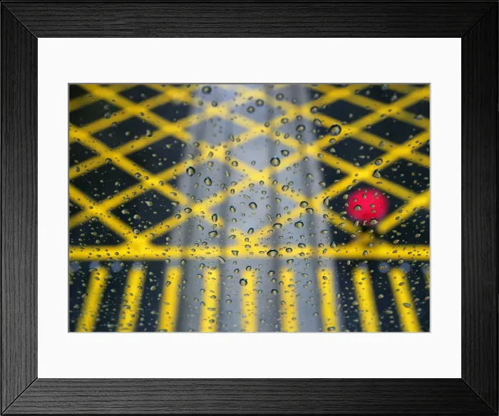 Framed Print : Resident walks across road under rainfall, seen through glass, in Hong Kong Framed Print : Resident walks across road under rainfall, seen through glass, in Hong Kong