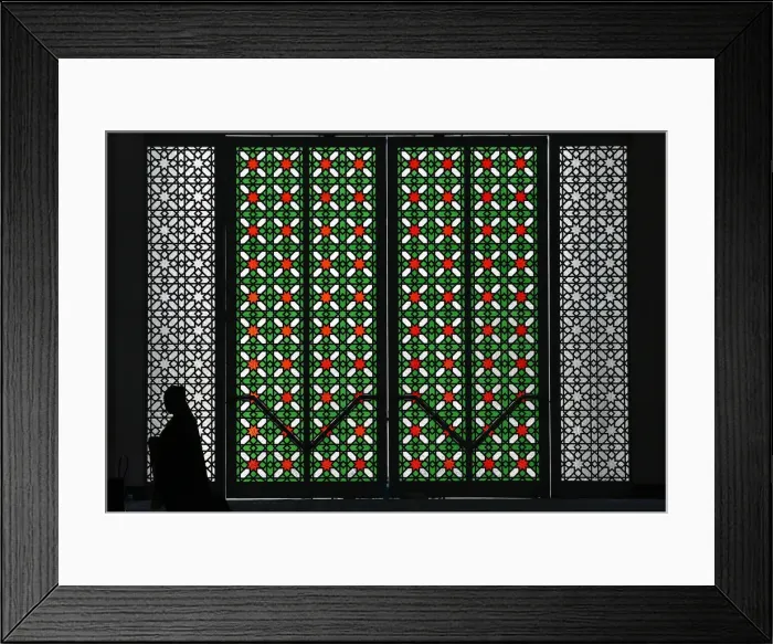 Framed Print : A Malaysian Muslim women is silhouetted after reading the Koran during the holy month Framed Print : A Malaysian Muslim women is silhouetted after reading the Koran during the holy month