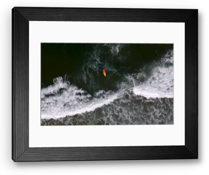 Framed Print : A surfer swims at Barra da Tijuca beach in Rio de Janeiro