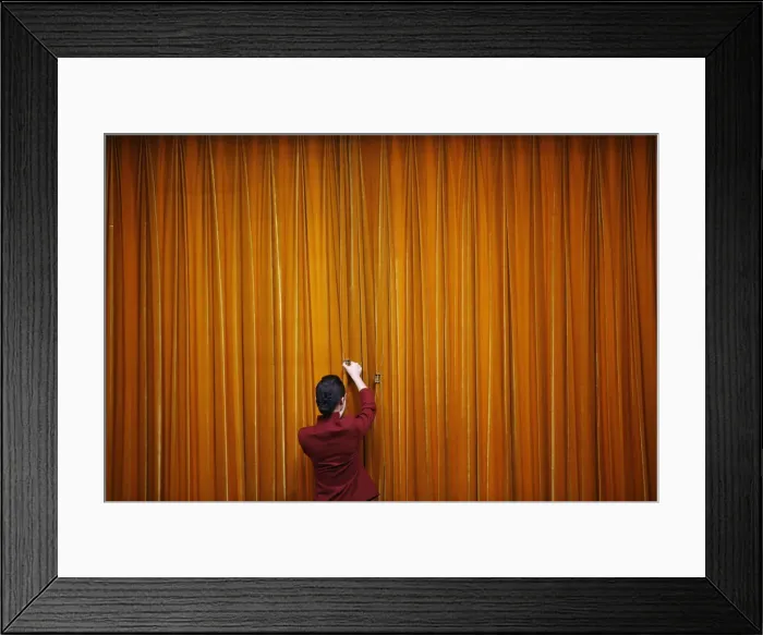 Framed Print : An attendant puts clamps on a curtain inside the Great Hall of the People during