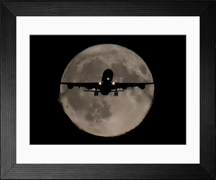 Framed Print : A passenger plane, with a full Harvest moon seen behind, makes its final landing approach