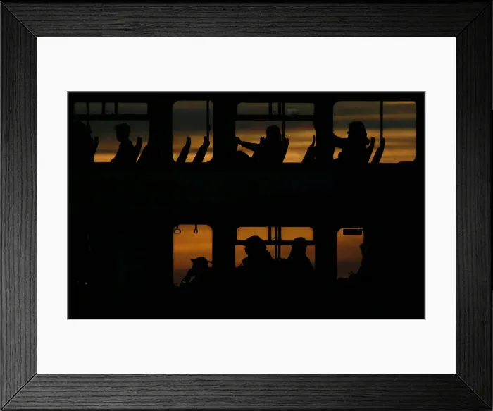 Framed Print : Passengers travel on a bus during sunset in London