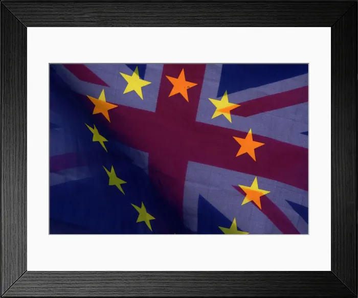 Framed Print : An EU flag and Union flag are seen flying together during an anti-Brexit protest near
