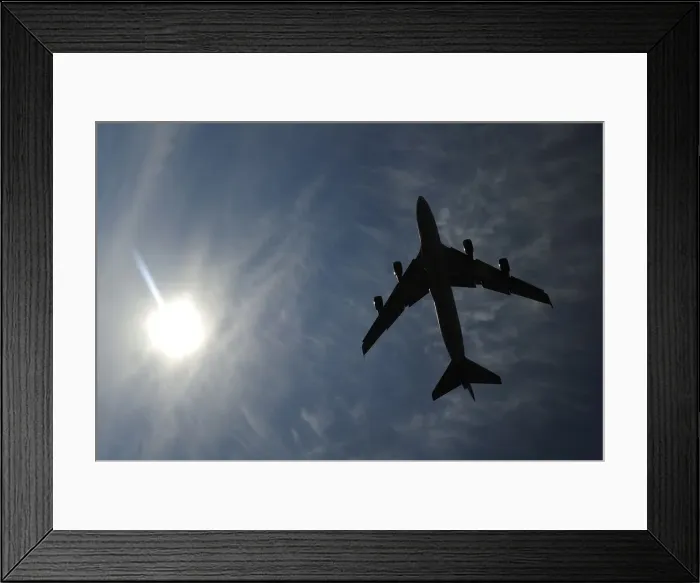 Framed Print : A jumbo jet takes off shortly after midday in London
