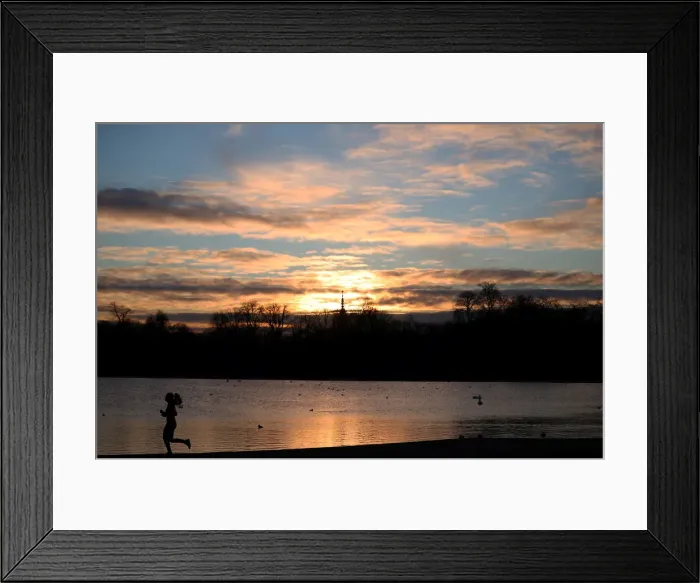 Framed Print : A jogger runs past the Round Pond in Kensington Gardens during sunrise in London Framed Print : A jogger runs past the Round Pond in Kensington Gardens during sunrise in London