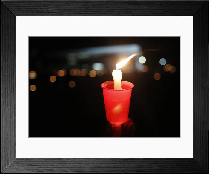 Framed Print : A lit candle is seen as Catholics keep vigil in front of Brazils Supreme Court, in Framed Print : A lit candle is seen as Catholics keep vigil in front of Brazils Supreme Court, in