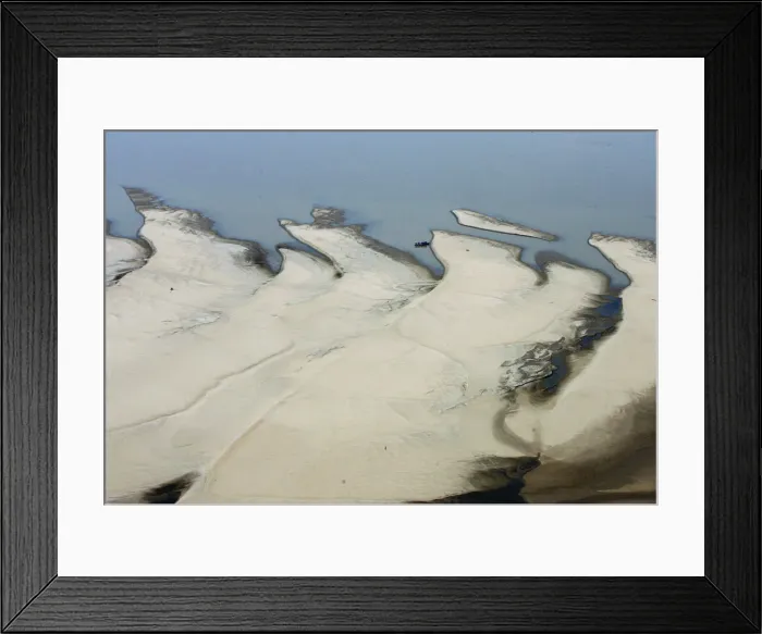 Framed Print : A boat moors to a sand bar exposed by the receding waters of the Rio Solimoes river Framed Print : A boat moors to a sand bar exposed by the receding waters of the Rio Solimoes river