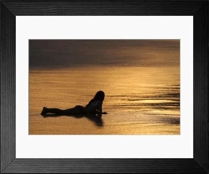 Framed Print : A child enjoys the Arpoador beach in Rio de Janeiro