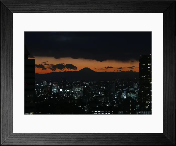 Framed Print : The silhouette of Japans highest mountain Mount Fuji is seen beyond buildings in Tokyo Framed Print : The silhouette of Japans highest mountain Mount Fuji is seen beyond buildings in Tokyo