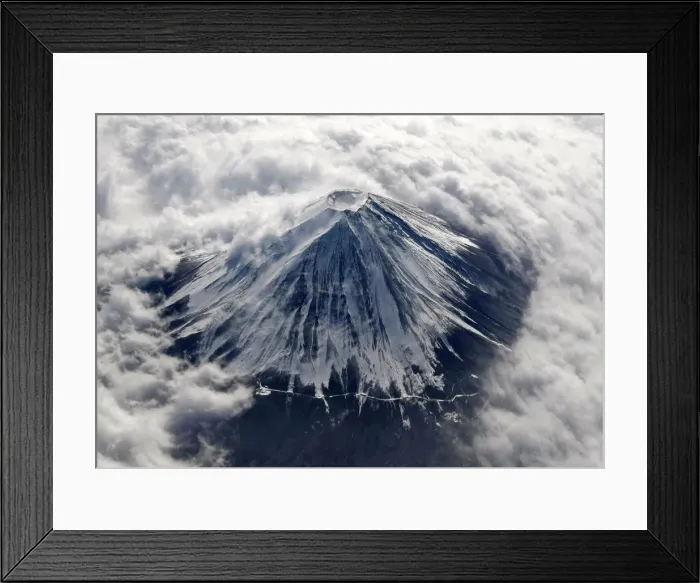 Framed Print : Japans Mount Fuji, covered with snow and surrounded by cloud, is seen from an airplane Framed Print : Japans Mount Fuji, covered with snow and surrounded by cloud, is seen from an airplane
