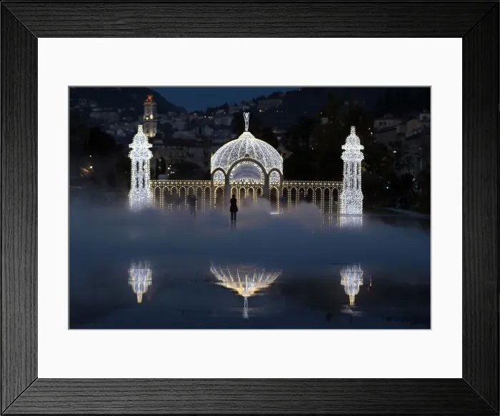 Framed Print : People stand in the mist as they look at a replica of the casino along the Promenade