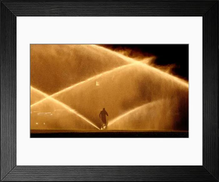 Framed Print : A jogger makes his way past sprinklers in Washington Framed Print : A jogger makes his way past sprinklers in Washington