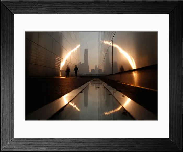 Framed Print : A man walks through the 9  /  11 Empty Sky memorial across from New Yorks Lower Manhattan