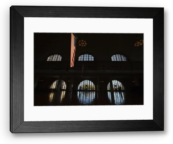 Framed Print : U. S. flag hangs in grand hall of the Ellis Island immigration museum building in New York Framed Print : U. S. flag hangs in grand hall of the Ellis Island immigration museum building in New York