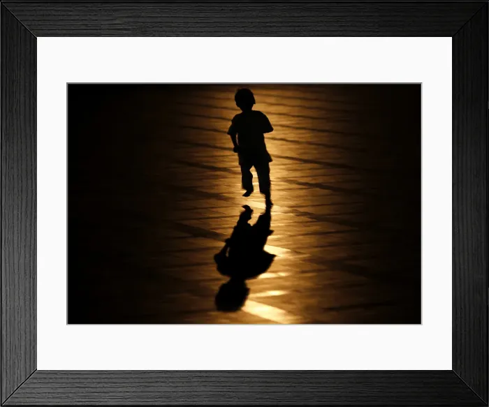 Framed Print : A muslim child runs after a mass prayer session marking the beginning of Ramadan Framed Print : A muslim child runs after a mass prayer session marking the beginning of Ramadan