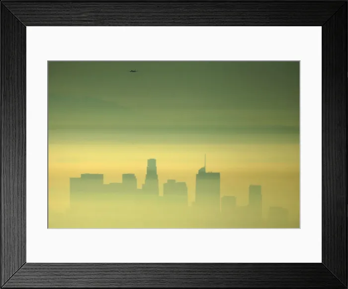 Framed Print : Downtown Los Angeles and an airplane are seen through the morning marine layer in Framed Print : Downtown Los Angeles and an airplane are seen through the morning marine layer in