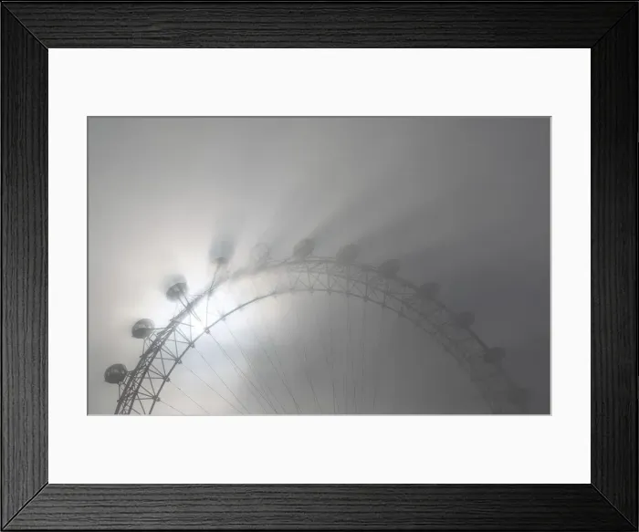 Framed Print : The pods on the London Eye casts shadows against a thick morning fog as the spring Framed Print : The pods on the London Eye casts shadows against a thick morning fog as the spring